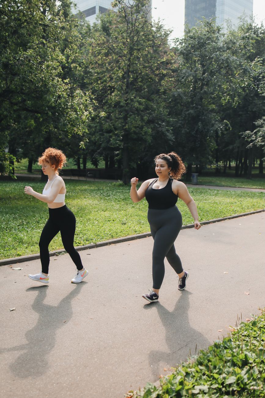 Two women power walking on a park path, a visual cue for the steady routines that matter more in maintenance than in a short challenge.