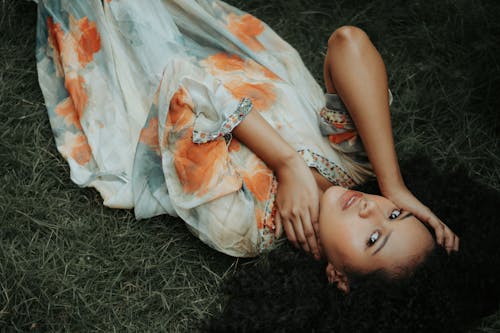 Free Woman Lying Down on the Grass Stock Photo