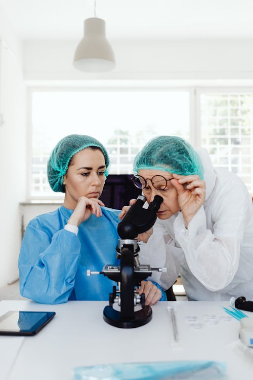 Women in Lab Coats Inside a Laboratory