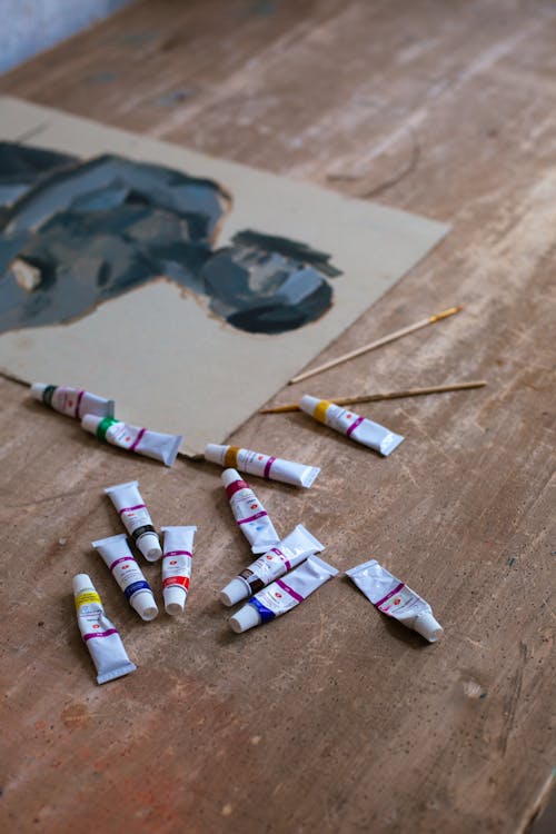 Free Paint Tubes on a Wooden Table Stock Photo