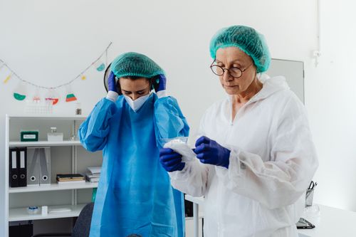Free Two scientists in protective gear work in a laboratory setting. Stock Photo