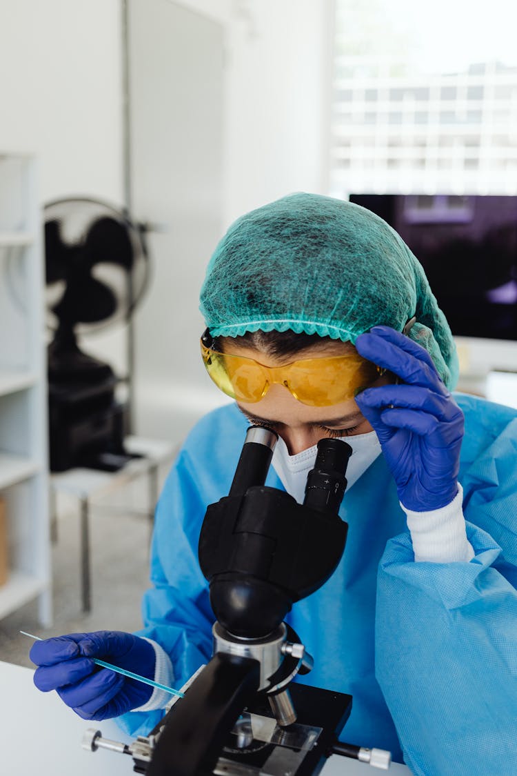 Laboratory Worker With Microscope