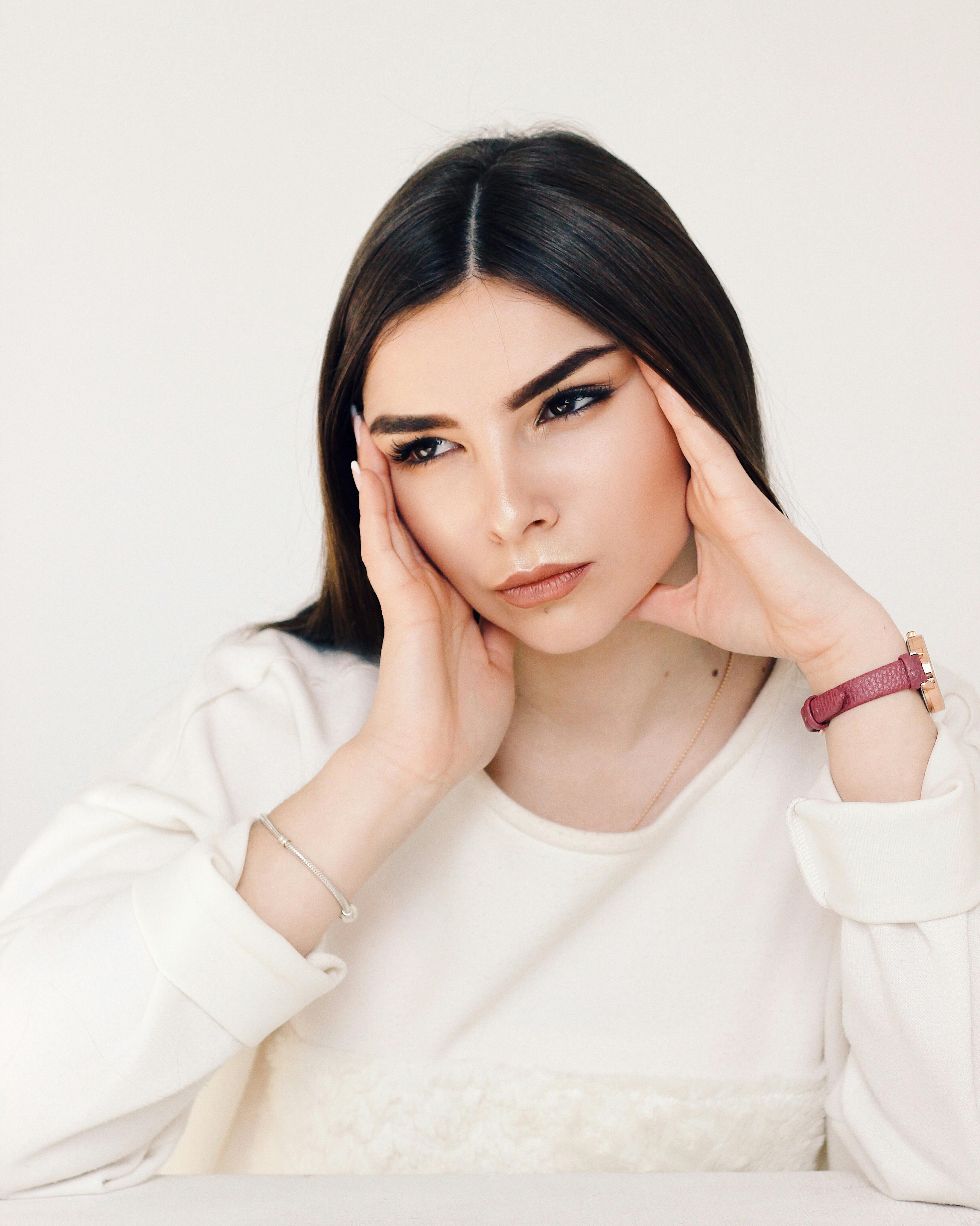 Studio portrait of a thoughtful young woman posing on a white background.
