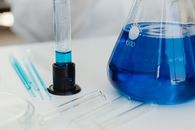 Close-Up View of an Erlenmeyer Flask beside a Graduated Cylinder
