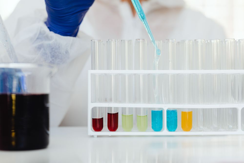 Researcher in protective gear preparing samples in a laboratory