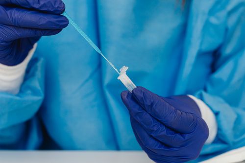 Free Close-up of a scientist using PPE to handle a sample in a laboratory. Stock Photo