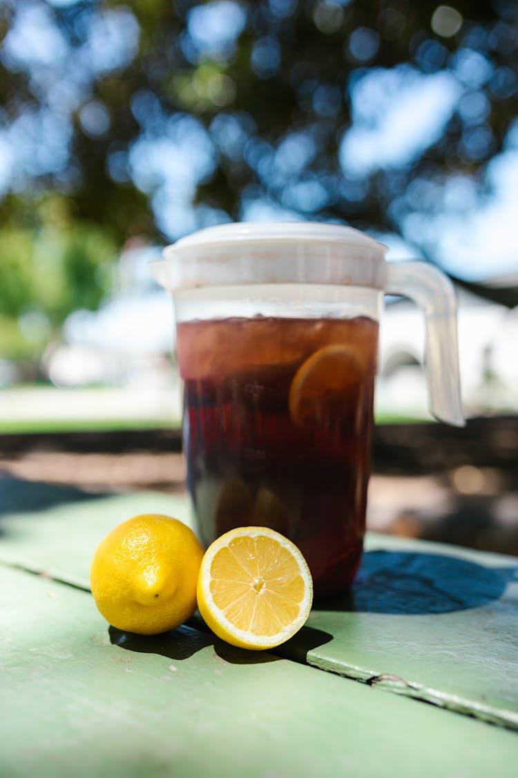 A Refreshing Lemon Tea Juice On A Wooden Surface