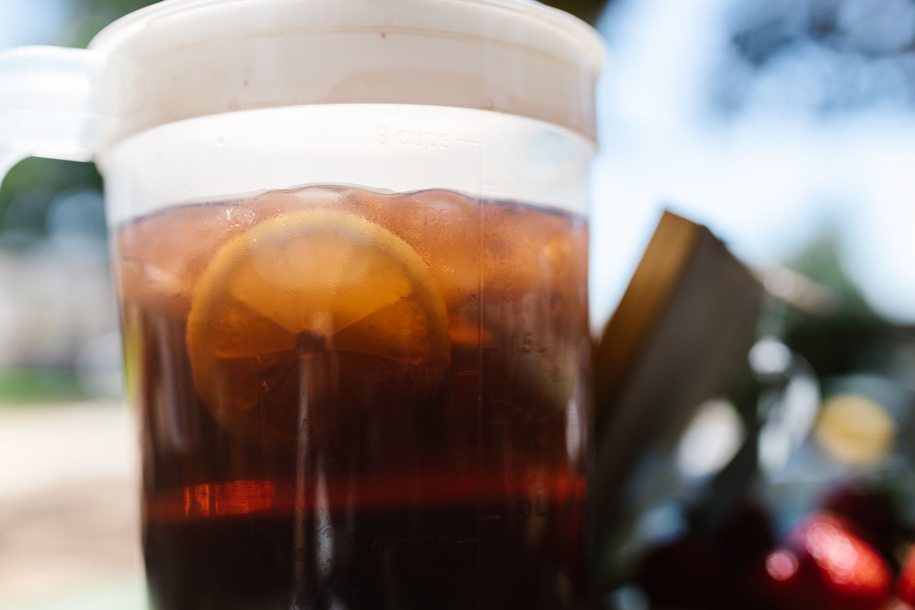 Cold bottled iced tea against sunny background