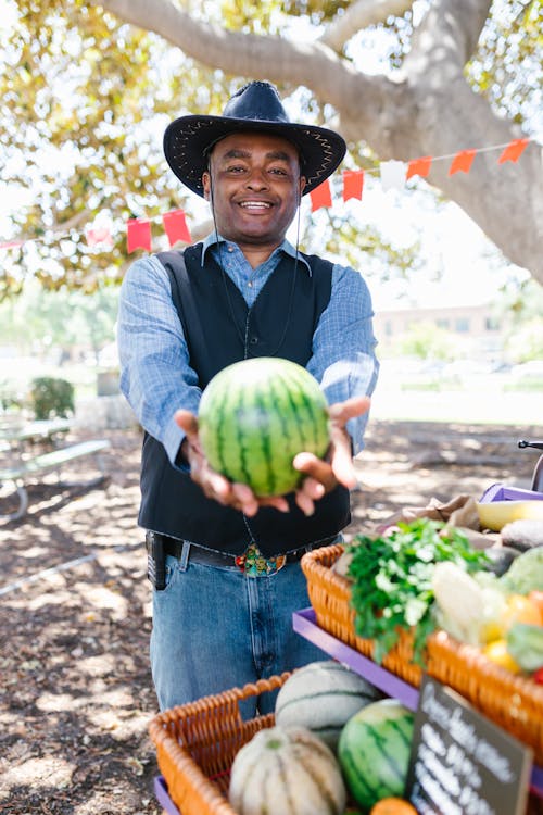A Man Holding a Watermelon