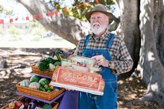Elderly man in denim jumper with basket of vegetables at outdoor farmers market.