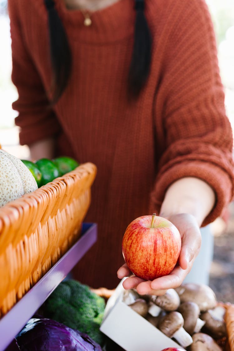 A Person Holding An Apple