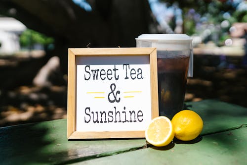 A Wooden Frame Near the Pitcher and Sliced Lemon on the Table