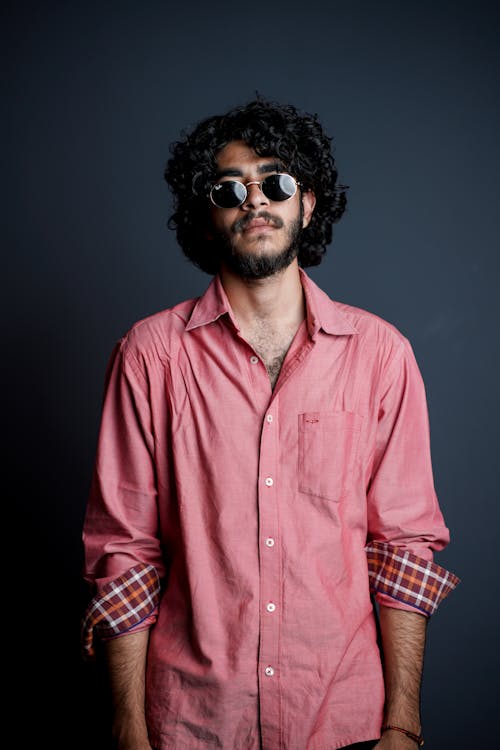 Free A Bearded Man in Pink Long Sleeves Wearing Sunglasses Stock Photo