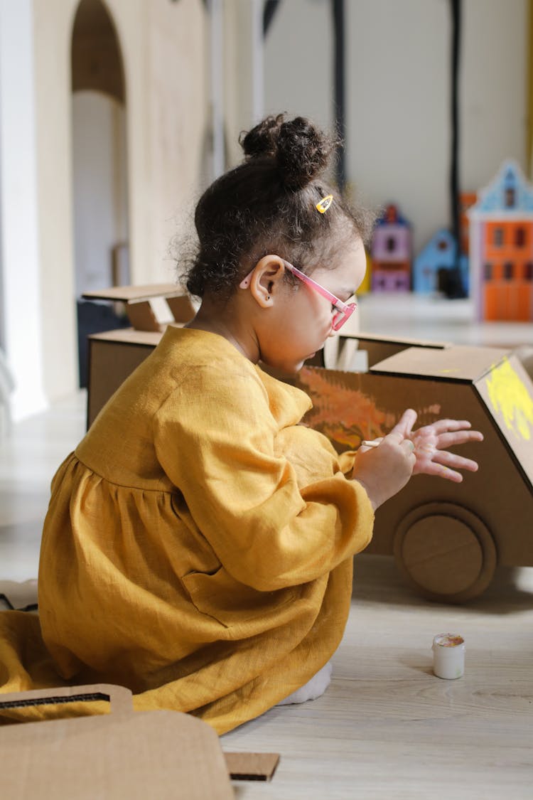 A Young Girl Painting Her Hand