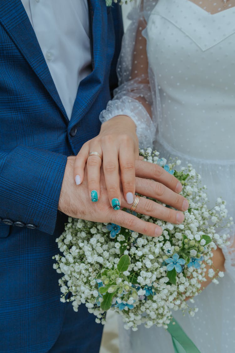 Close-up Of A Bridal Couple Holding Hands