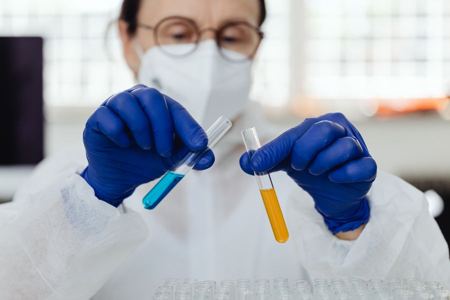 Lab scientist holding test tubes