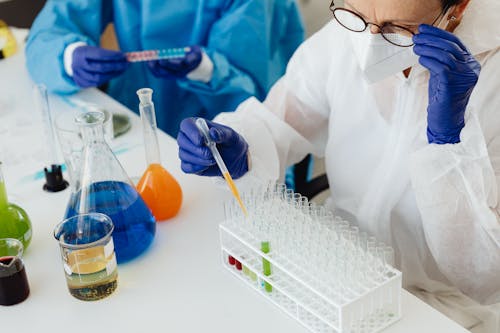 A Scientist Holding a Drop Pipette