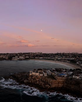 A tranquil aerial view of Bondi Beach, NSW at dusk, showcasing its beautiful coastline and serene atmosphere.