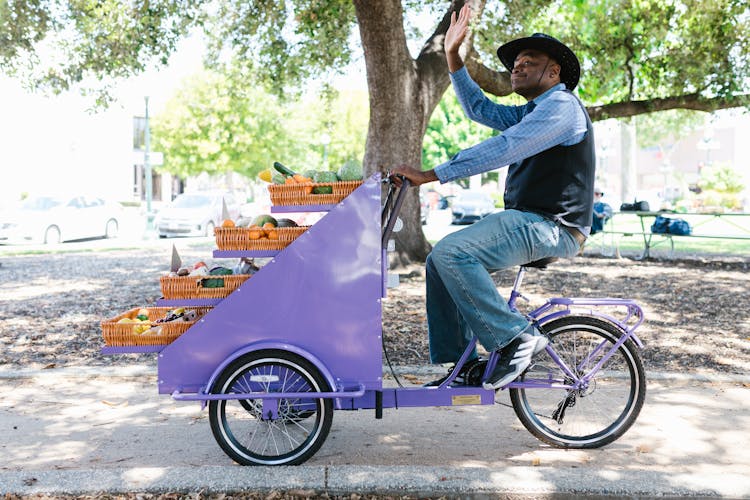 A Man Riding A Tricycle