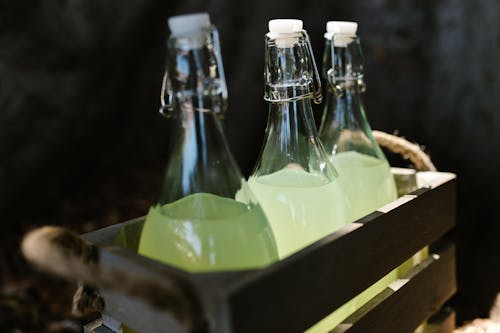 Clear Glass Bottles in a Wooden Crate
