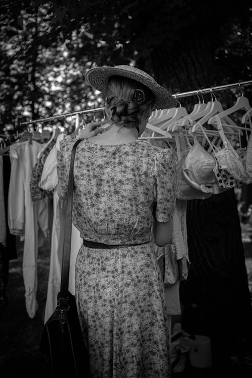 Grayscale Photo of a Woman in Floral Dress Wearing Hat