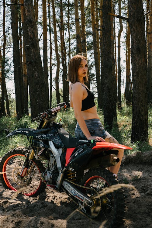 Sexy Woman Sitting on a Dirt Bike