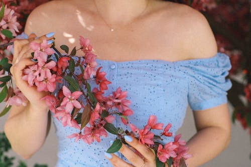 Close-Up Shot of a Pretty Woman Holding Pink Flowers