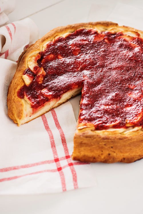 Close-Up Shot of a Tasty Pizza on a White Textile