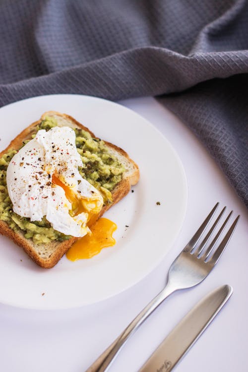 Close-Up Shot of a Bread with Egg on a Plate