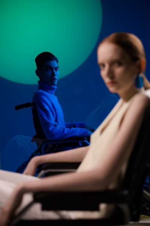 Free Stylish photo of a diverse duo in focus with vivid neon lights, emphasizing modern fashion. Stock Photo