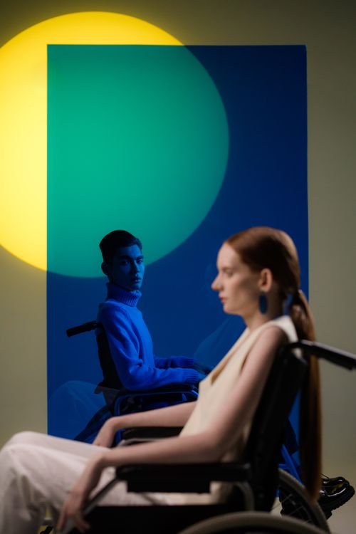 Free Creative studio shot of two people in wheelchairs against colorful backdrop. Stock Photo