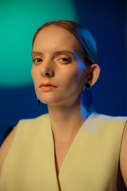 Close-Up Shot of a Pretty Woman Wearing Blue Earring