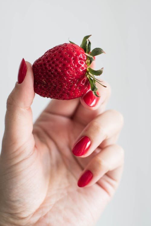 A Person holding Strawberry