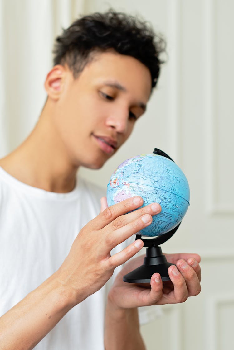 A Man Holding A Globe