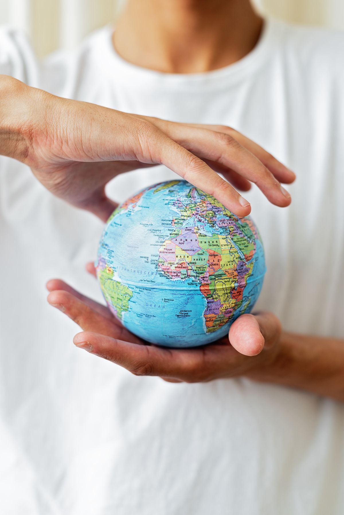 Hands holding a globe