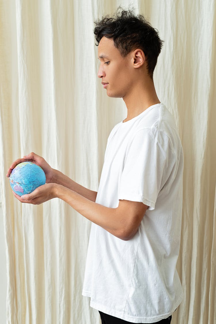 A Man Holding A Globe