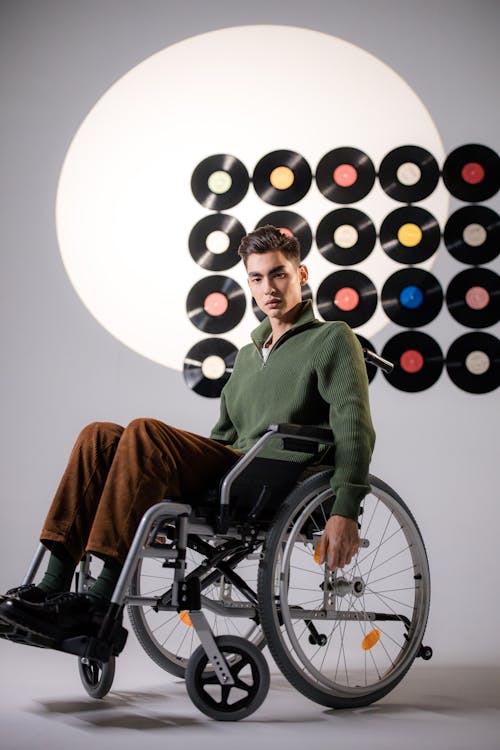 Free A Man in Brown Pants Sitting on the Wheelchair Stock Photo