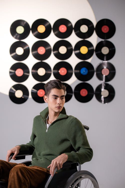 Man in Green Long Sleeves Sitting on Wheelchair