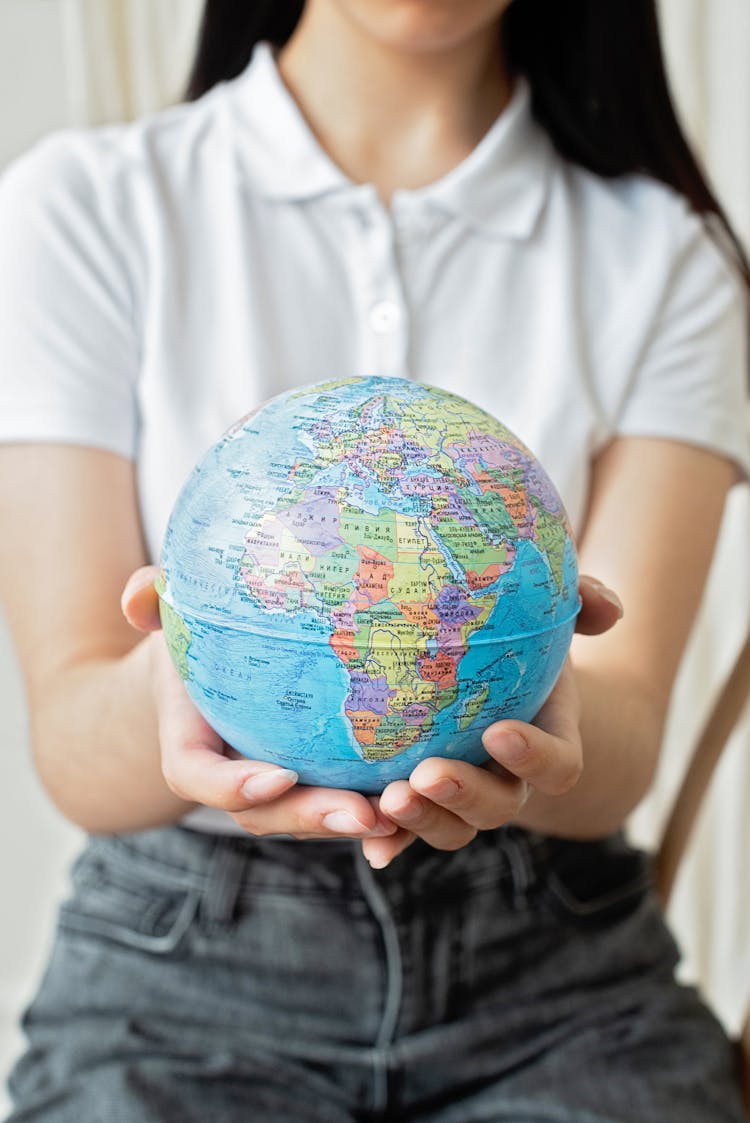 A Woman Holding A Globe