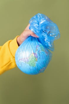 Conceptual image of Earth wrapped in a plastic bag, symbolizing environmental concerns.