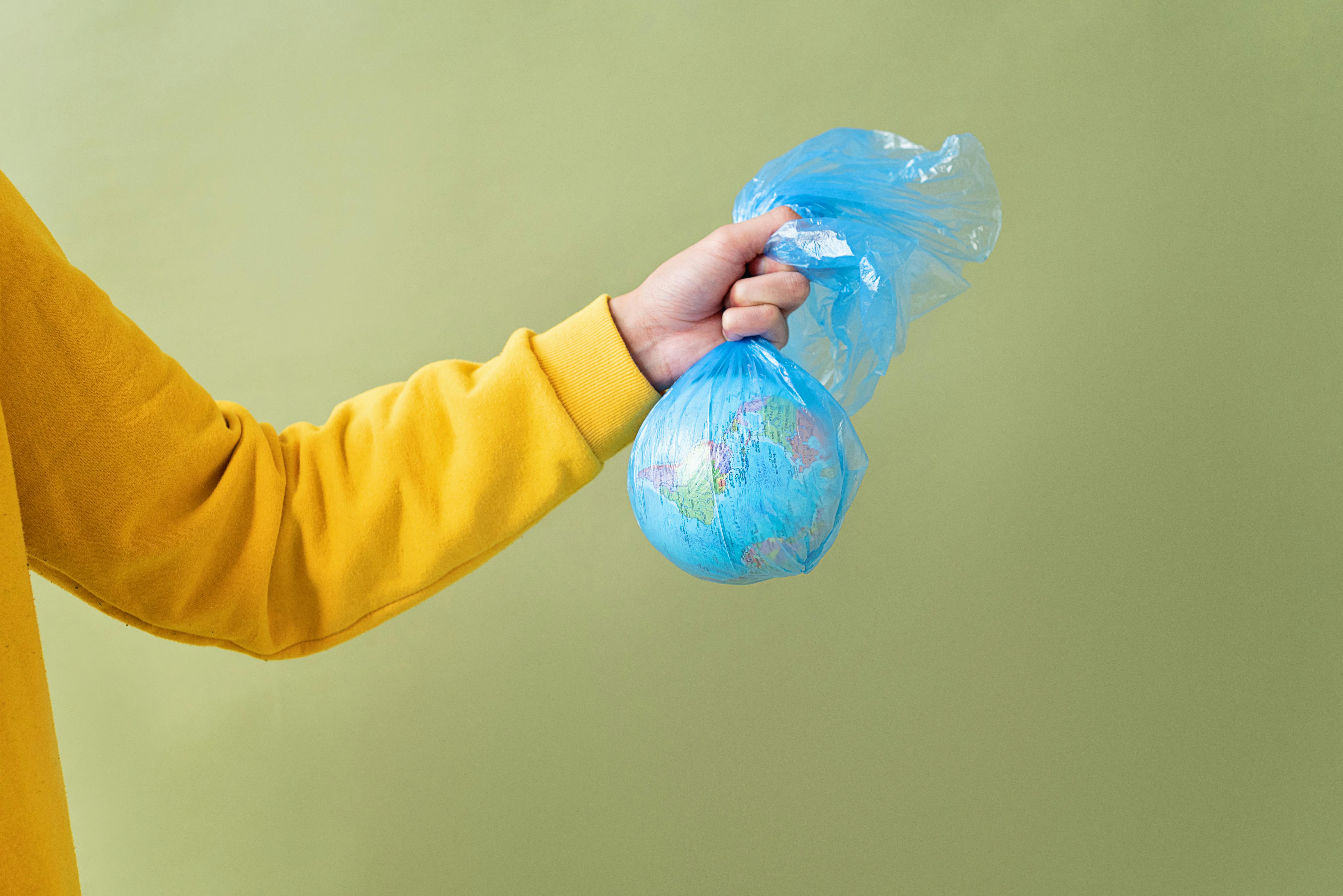 person holding a globe in the plastic