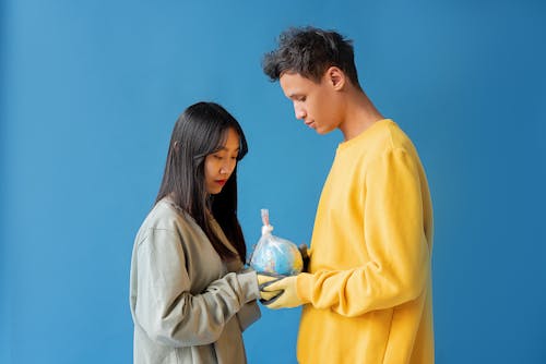 Free Couple Holding a Globe in the Plastic Stock Photo