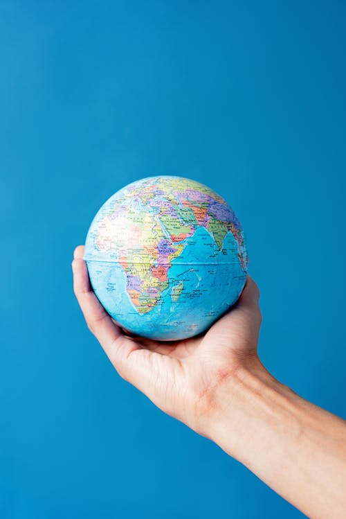 Free Close-Up Shot of a Person Holding a Globe Stock Photo