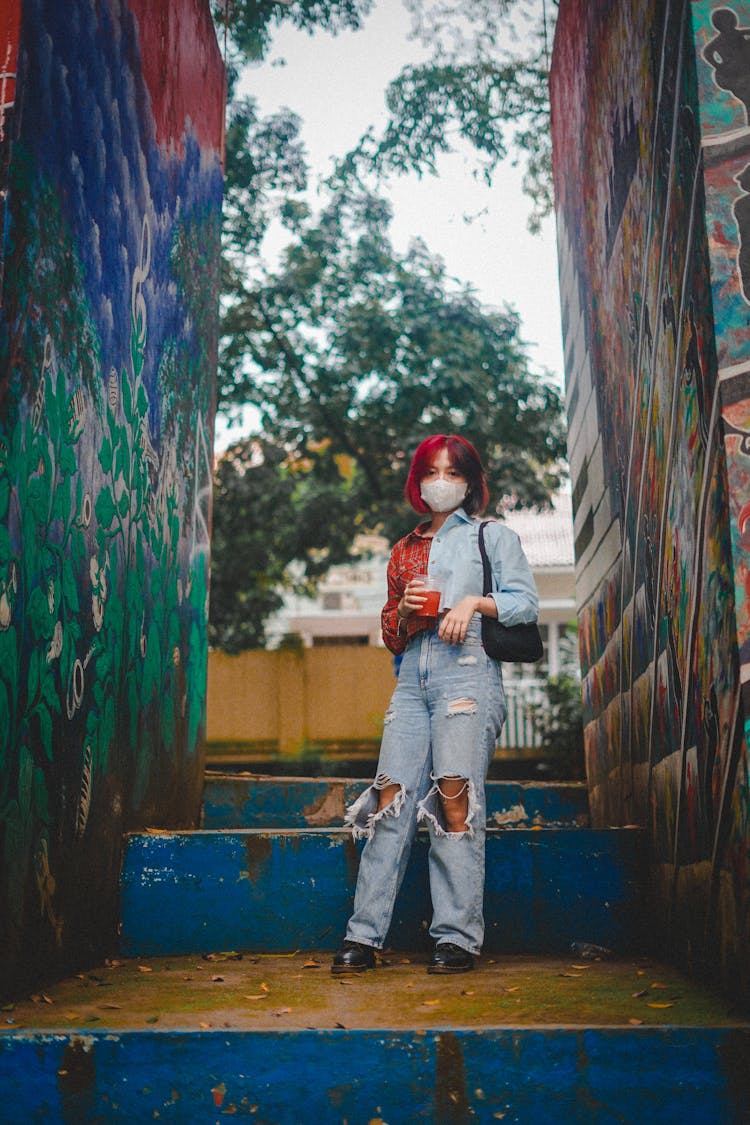 Woman Standing Between Painted Walls