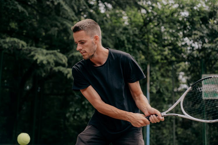 Man In Black Crew Neck T-shirt Playing Tennis