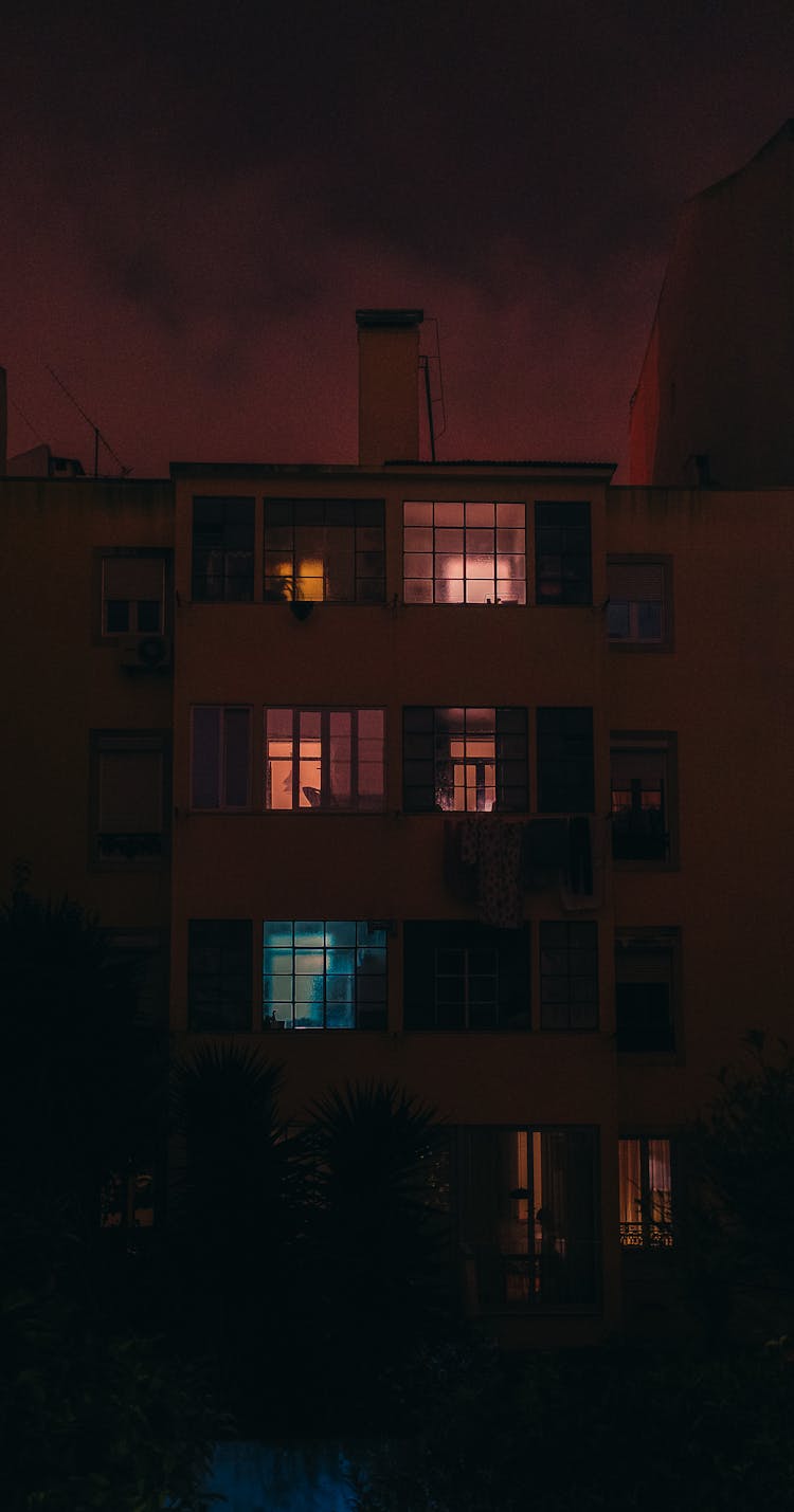 Concrete Building With Glass Widows During Night Time