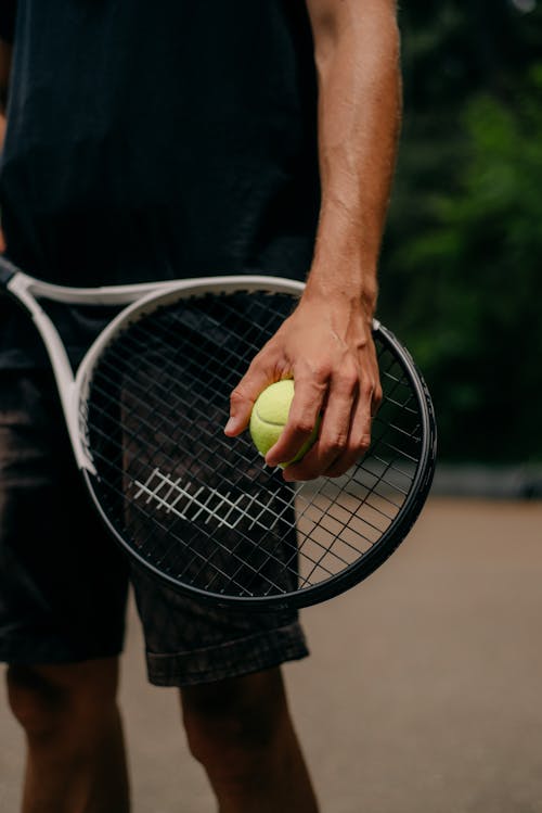A Person Holding a Tennis Ball