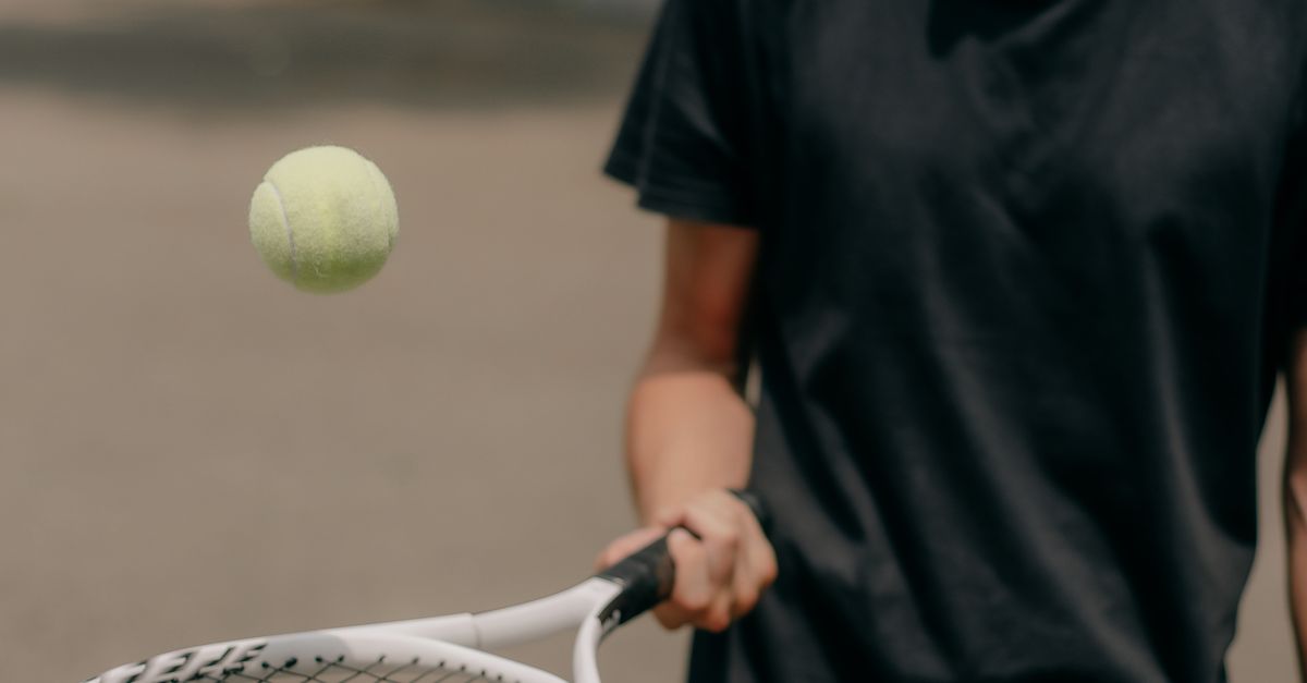 Man Using Tennis Racket A Man using a Tennis Racket and Tennis Ball · Free Stock Photo
