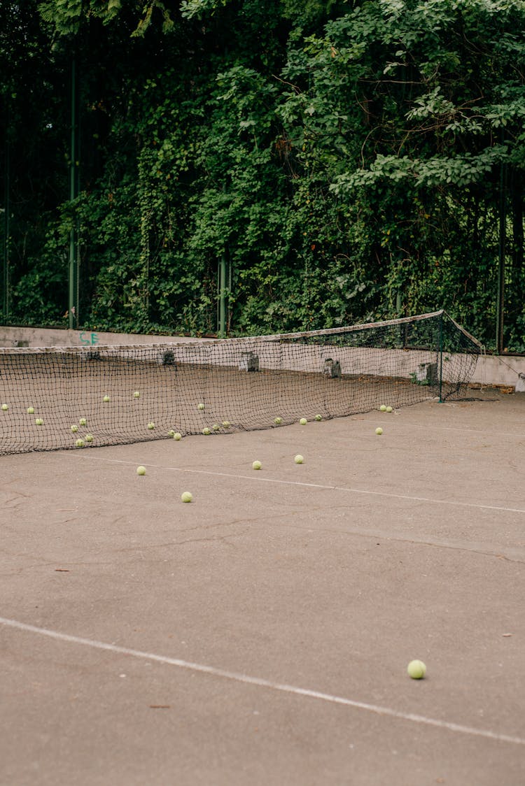 Tennis Balls And Net On A Tennis Court