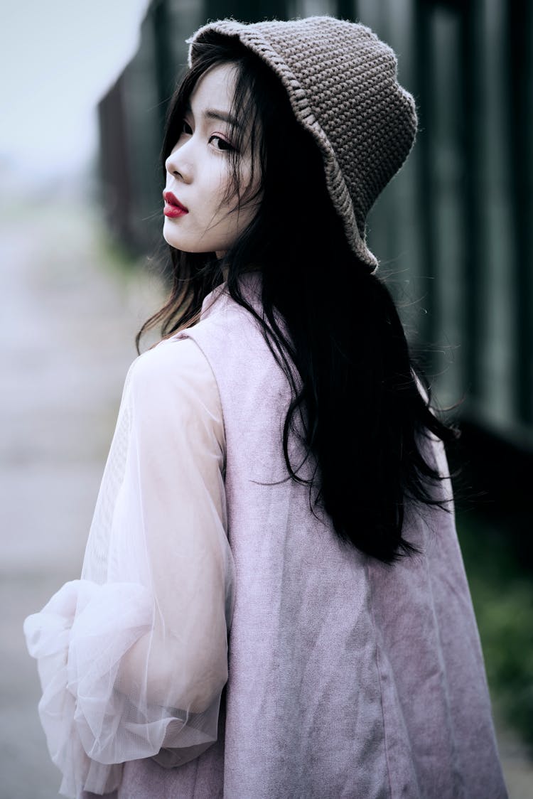 A Pretty Woman Wearing A Crochet Beanie